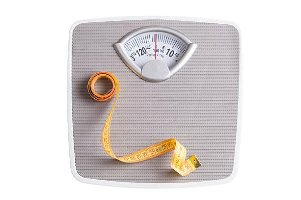 Tape Measure on Weight Scale isolated on white Weight scale (dummy)